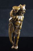 A Japanese stained ivory netsuke of a woman clambering on the back of an oni, early 20th century,
