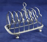 A George III silver seven bar toast rack by Emes & Barnard, of rounded rectangular form, with ring