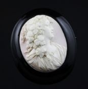 A jet mounted oval cameo brooch, carved with the bust of a lady to sinister, 2.5in.
