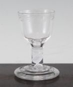 An opaque twist firing glass, c.1765, the bucket shaped bowl with wheel engraved flower and