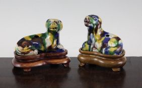 A pair of Chinese four colour glazed biscuit water droppers, in the form of recumbent hounds, 3.7in.