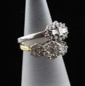 An Art Deco style 18ct white gold and diamond cluster dress ring, set with round and baguette cut