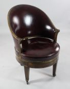 An early 20th century French mahogany revolving tub chair, with red leather upholstered back and