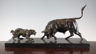 An early 20th century animalier group of a hound barking at a bull, on black marble plinth, 22in.