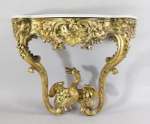 A mid 18th century German giltwood console table, with serpentine white marble top and foliate