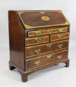 A George III mahogany satinwood banded bureau, the fall front with oval paterae and corner fan