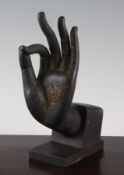A South East Asian bronze Buddha`s hand fragment, possibly Khmer, 8.5in. (21.5cm)