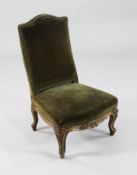 A Louis XV design carved beech child`s chair, with brass studded green velvet upholstery