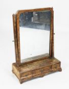 An early 18th century figured walnut toilet mirror, the box base fitted three drawers, 1ft 7in. H.