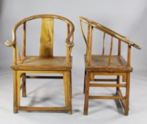 A pair of 19th century Chinese elm open arm chairs, with `horseshoe` backs and rattan seats