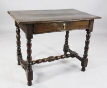 A late 17th century oak side table, the overhanging top above a single drawer, on bobbin supports,