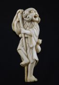 A Japanese ivory netsuke of Tekkai Sennin, 18th century, in standing pose holding a staff, with a