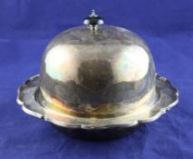 A George V silver muffin dish with cover and liner, of shaped circular form, with engraved