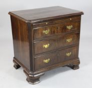 An 18th century Dutch walnut chest, with brushing slide and three graduated long drawers, on ogee