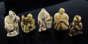 Five Japanese stained ivory figures, c.1940, three depicting tradesmen, the fourth a Samurai and the