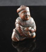 A Japanese boxwood netsuke of a seated boy holding a mask, 19th century, two character