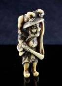 A Japanese marine ivory netsuke of Shoki and an oni, 19th century, the oni clambering across his