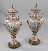 A pair of large Sevres style porcelain vases, each painted with classical figures in landscapes,