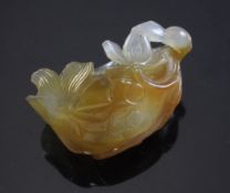 A Chinese agate brushwasher, 19th / 20th century, carved as a curled lotus leaf with relief goldfish
