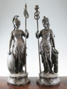 A pair of late 19th century spelter classical female figures, both on circular bases, one titled `