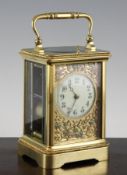 An early 20th century French gilt brass hour repeating carriage clock, the enamelled arabic dial set