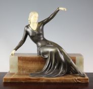 An Art Deco bronzed spelter and ivorine figure of a seated lady waving farewell, on onyx plinth,