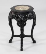 A 19th century Chinese hardwood vase stand, with octagonal red marble inset top, carved with