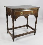 A William and Mary oak style table, with single drawer over a shaped frieze, on baluster supports