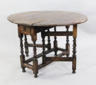 A William & Mary yew and walnut oval gateleg table, c.1690, the oval yew wood top above a drawer and