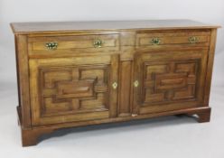 A late Victorian mahogany dresser base, with two drawers over geometric panelled cupboard doors,