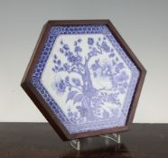 A Chinese blue and white hexagonal tile, 18th century, painted with prunus and flowers within