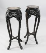 A pair of late 19th century Chinese rosewood jardiniere stands, with circular inset pink marble tops