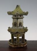 A Chinese green glazed pottery model of a two tier pagoda, Han dynasty, modelled with figures in