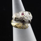 An 18ct gold and diamond set leopards head dress ring, with cabochon ruby set eyes, size E.