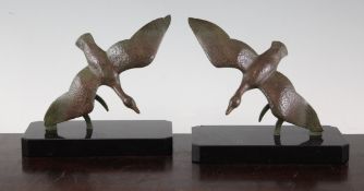 F. H. Danvin. A pair of silvered bronze and variegated marble bookends, modelled as seated birds,