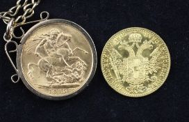 A George V 1915 gold full sovereign in a 9ct gold mount on chain and an Austrian 1915 re-strike