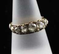 A late Victorian 18ct gold and graduated five stone diamond ring, set with old mine and rose cut