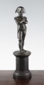 A 19th century bronze figure of Napoleon, standing with arms crossed on a circular pedestal,