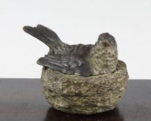 A 19th century Austrian cold painted bronze inkwell, modelled as a bird and nest, the underside of