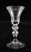 A George II baluster wine goblet, c.1725-30, the bell bowl above a ball knop and inverted baluster