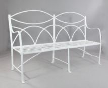 An early 19th century white painted wrought iron garden bench, with lunette pierced back, reeded