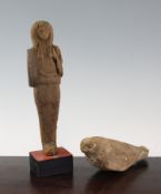 Two Egyptian carved wood figures, possibly from Antiquity, the first of sarcophagus shape with later