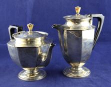 A George V silver teapot and matching hot water pot, of tapering octagonal form, with ivory knops