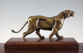 Attributed to Irenee Rochard. An Art Deco bronze model of a lioness, on associated mahogany