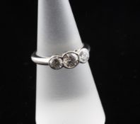 A platinum and three stone diamond ring, the three round brilliant cut stones with a total weight of