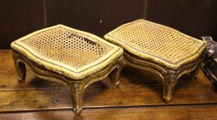 A pair of Louis XV style carved giltwood foot stools, with caned tops and scroll legs, 1ft 1in. x