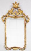 A Chippendale style carved giltwood wall mirror, with pierced scrolling acanthus crest, 4ft 4.5in. x