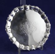 A George II silver waiter, of shaped circular form, with engraved armorial and shell border, on