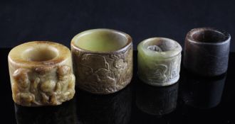 Four Chinese jade archer`s rings, Ming dynasty or later, the first of green russet stone carved in