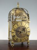 A late 19th century brass lantern style mantel clock, with traditional engraved case and twin